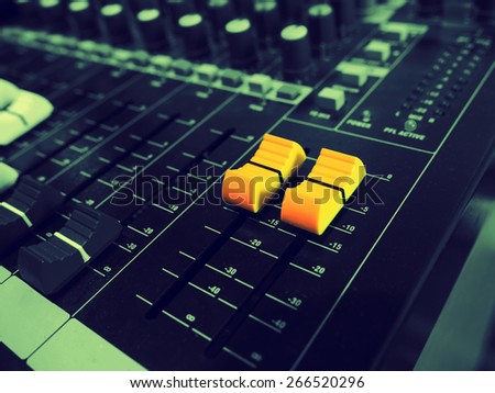 A yellow sound mixer buttons control with black and white  sound mixer buttons in vintage style.
