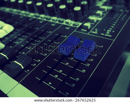 A blue sound mixer buttons control with black and white  sound mixer buttons in vintage style.
