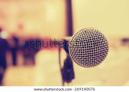Microphone in concert hall or conference room with de-focused bokeh lights in background. : Vintage style and  filtered process
