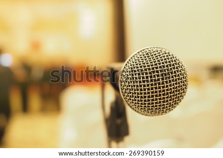Microphone in concert hall or conference room with blurry background. Extremely shallow dof.