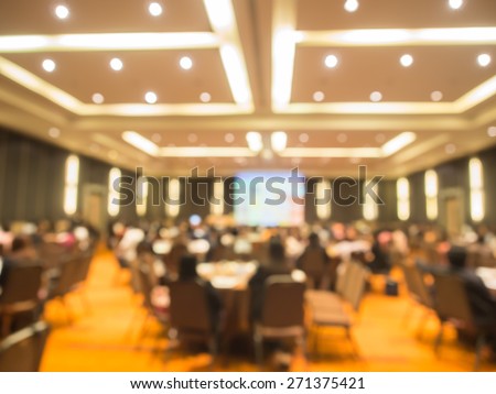 Abstract blurred  people in  big meeting or conference room for background. Warm tone photo.