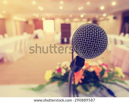Microphone in  hall or conference room with defocused Stock market number on screen display  background. Concept for Business Conference.