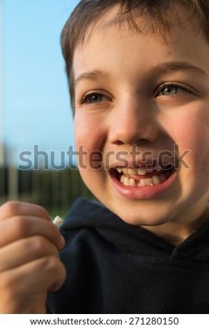 Young boy with missing front tooth, waiting for tooth fairy