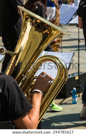 Little Boy with White Hat and Brass Lacquered Trumpet during Outdoor Concert