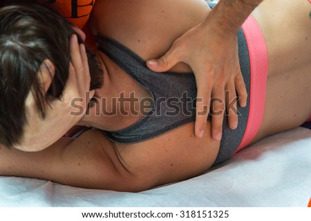 Chiropractor doing Manual Adjustment on Athletic Girl\'Spine after Sport Activity