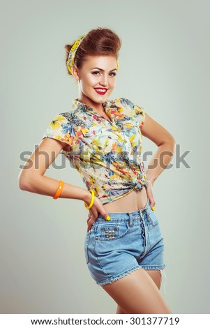 The glamour smiling pin up girl in jeans shorts