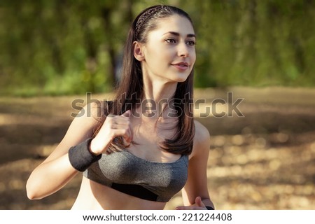 Girl in sport on the forest background. Likes to run