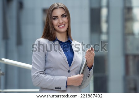 beautiful businesswoman with laptop on the background of the business center