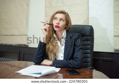 Businesswoman think looking up to empty copy space, young attractive business woman think, idea, hold folder pen on chin. concept pondering in modern office
