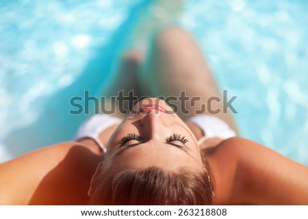 Portrait of a sexy girl in a swimming pool. Top view