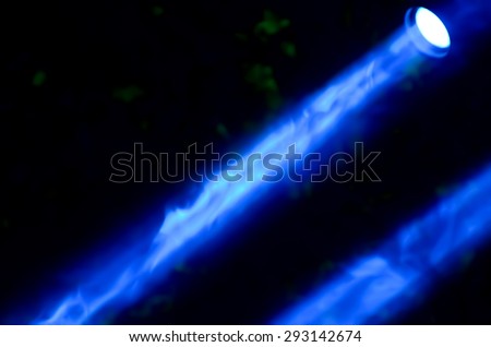 Beam of blue light on black background. Applied to a searchlight, torch.