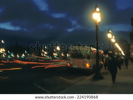 France, Paris, bus stopped next to sidewalk at night