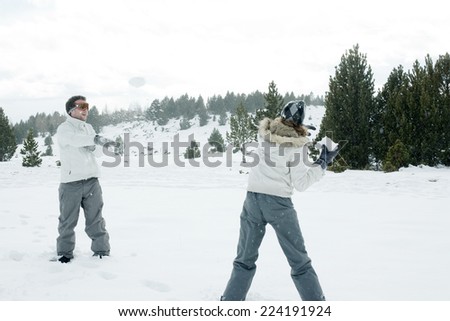 Young friends having snowball fight