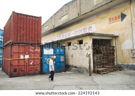 China, man walking through industrial area