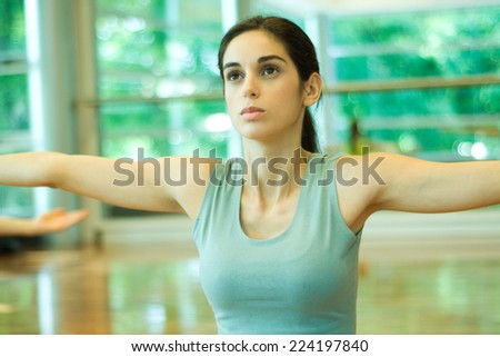 Young woman holding arms out, waist up