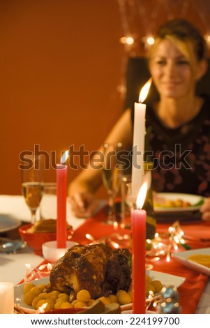 Woman eating candle lit dinner, selective focus