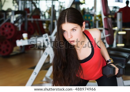 Fitness time. Muscular fitness woman doing exercises. girl in the gym. sport, gym and lifestyle - concept of healthy lifestyle. biceps, arm, workout