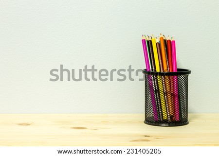 pencils of different colors in a metallic glass stationery