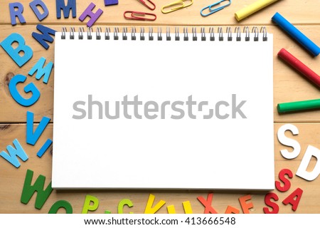 Blank open notebook with numbers and English alphabets on wooden background ready for text