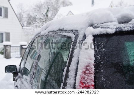 Car in the winter covered with snow