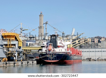 GENOA, ITALY - FEBRUARY 21, 2013: The bulk carriere registered in Liberia ENERGY LULA. Cargo ship designed for the transportation of coal. In the background the lighthouse, symbol of the port Genoa.