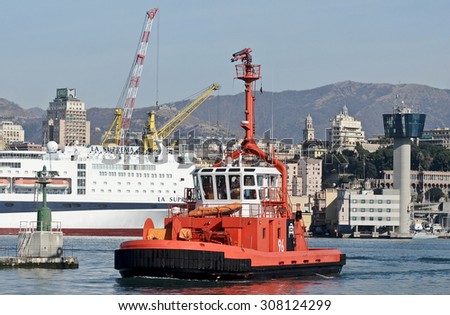 GENOA, ITALY - FEBRUARY 23, 2012:  A tugboat in the commercial port. In the background the tower pilots who in May 2013 was shot down by the vessel RO RO Jolly Nero.