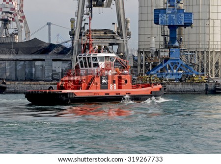 GENOA, ITALY - FEBRUARY 22, 2010: The tug BRASILE maneuvering in the industrial area of the port of Genoa.