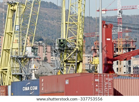GENOA, ITALY - FEBRUARY 23, 2012: Containers and cranes on the docks of the commercial port of Genoa.