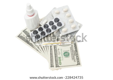Pills in a blister pack, thermometer and nasal spray with US dollars isolated on a white background
