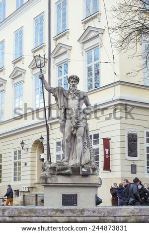 LVOV, UKRAINE - January 11, 2015: An ancient statue of Neptune in the central square of Lviv - Market (Rynok) Square near City Hall. Lviv - city in western Ukraine.