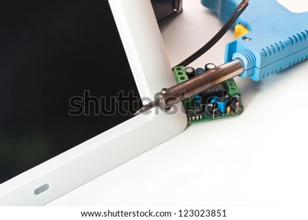 Electric soldering irons and screen tablet on a white background