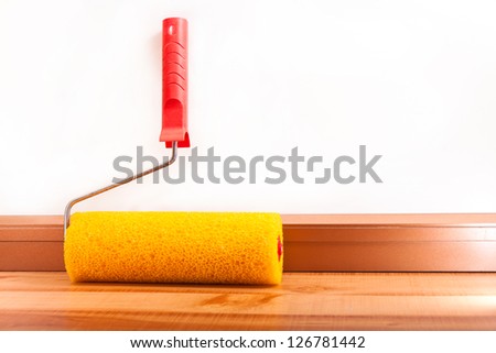Yellow roller for painting walls