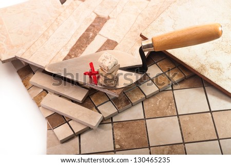 Trowel with a stack of tiles made Ã?Â¢??Ã?Â¢??of stone, and a red cross on a background of ceramic tiles