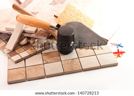 Ceramic tile, trowel, a rubber hammer, sponge, crosses on a white background