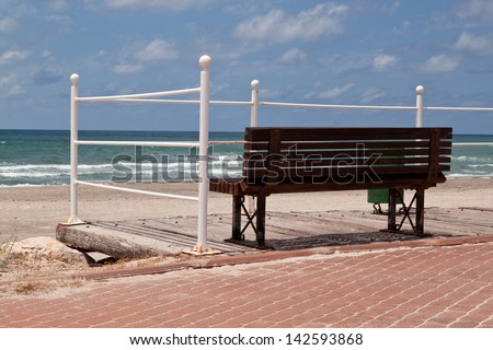 Bench for rest on a walking path near the sea