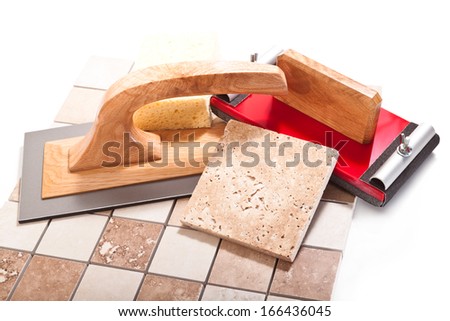 Tiles, spatula, sandpaper on a white background