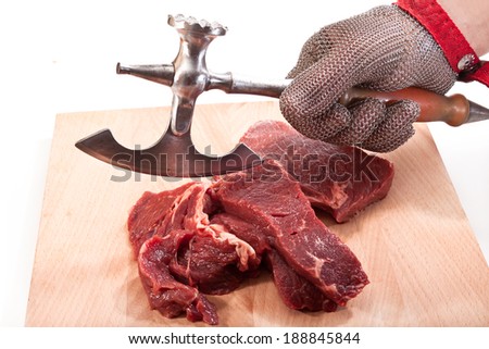 Hand in glove with the ax chain mail and beef on a cutting board