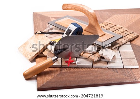 Tiling to floor and walls, a trowel, a meter on a white background