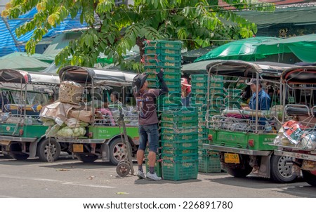 BANGKOK,THAILAND - SEP 20:Unidentified man  Basket storage of vegetable at Pak Khlong Talat  market in Bangkok,Thailand on 20 September 2013.