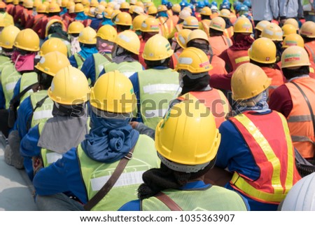 Group of construction worker helmet and safety uniform meeting on morning talk before work at warehouse under construction site