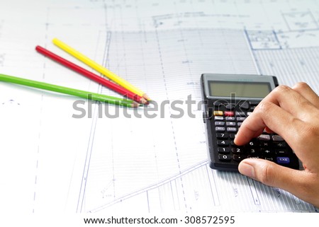 Engineer Calculate cost  architectural building project on architectural blueprint