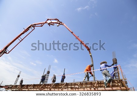 SAKON NAKHON OCTOBER 12 : the worker casting concrete slab with mobile crane and concrete pump car at new toyota showroom building  on October 12, 2015 in Sakon nakhon, Thailand.