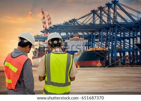 Inspector or audit checking the Cargo ship port in the harbor at sunset time
