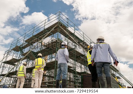 Civil engineer and safety officer in spec steel truss structure scaffolding risk analysis in construction site