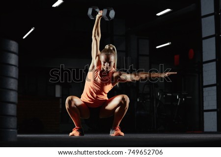 Beautiful sportswoman exercising at the gym doing overhead kettlebell squats copyspace motivation beauty confidence crossfit athletic body feminine powerful muscles weight gain concept. CrossFit woman