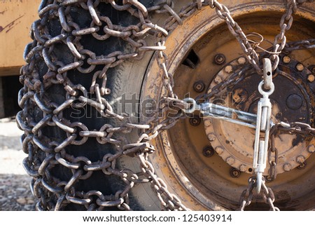 Close-up of snow chain on a big tire. Snow chains on a big wheel