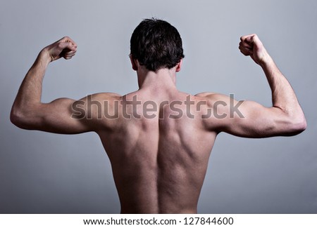 Muscular male back over gray background