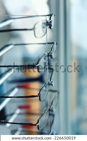 Eye glasses shop. Detail from eye glasses shop. Glasses on blur background.