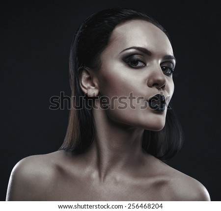 Closeup portrait of young sexy beautiful woman holding an ice cube in her mouth.