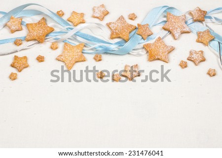 Christmas stars cookies with powder sugar on white textile background